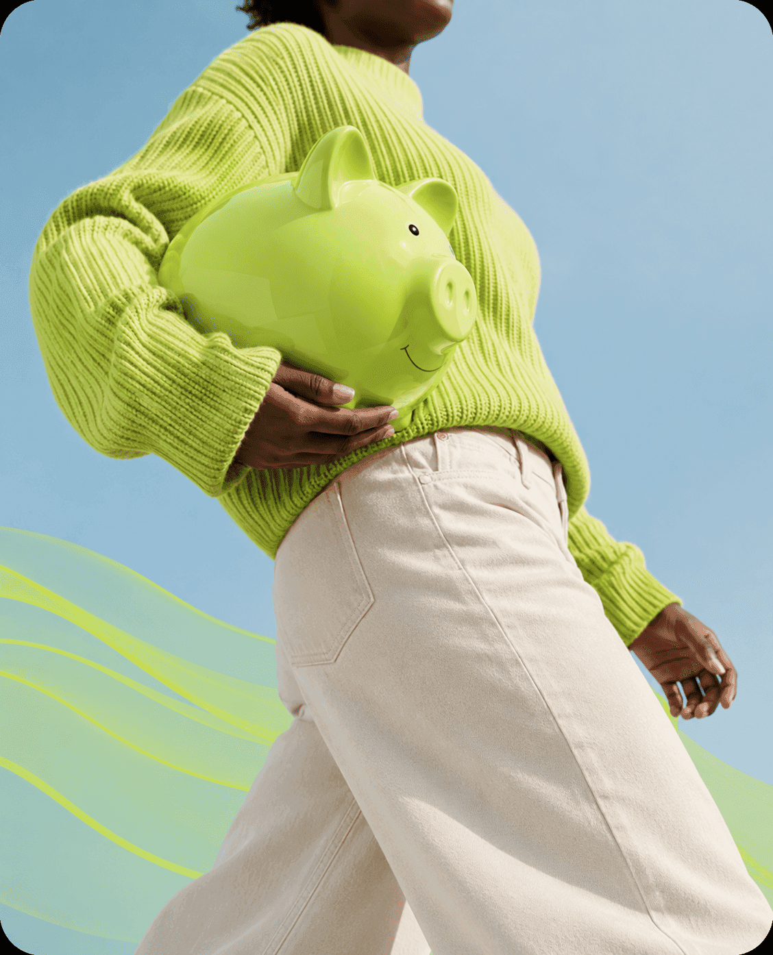 Person holding a green piggy bank